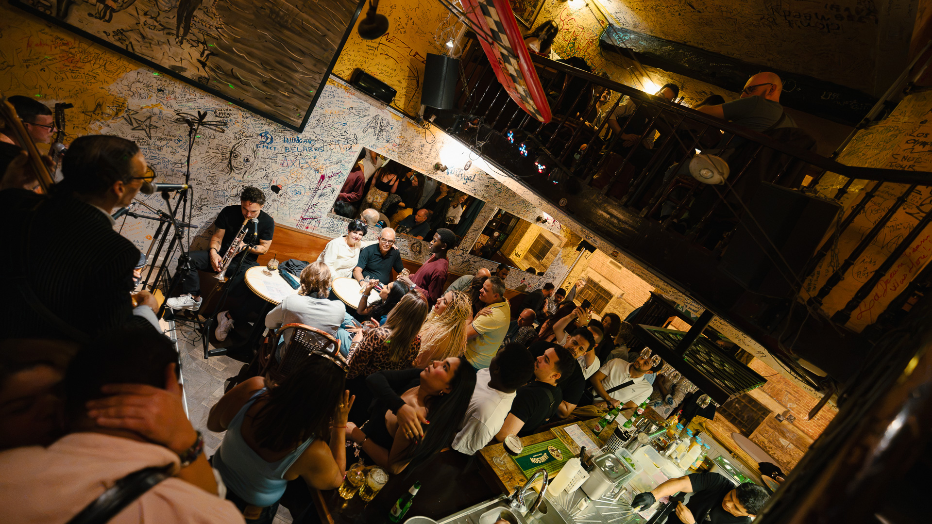 Customers signing the wall at Che Habana Café, Brussels
